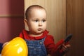 Girl with construction tools. Little girl in jeans dress. little girl in a helmet. Child protection and safety. baby building.