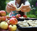 girl cook apple croissants with own apples from garden