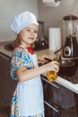 A girl cook cooks scrambled eggs. Stage one pours sunflower oil. Soft focus Royalty Free Stock Photo