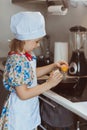 A girl cook cooks scrambled eggs. Stage three pours the egg into the frying pan. Soft focus Royalty Free Stock Photo