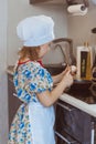 A girl cook cooks scrambled eggs. Stage two breaks the egg. Soft focus Royalty Free Stock Photo