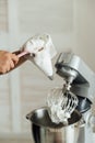 The girl cook puts the cream from the mixer into the mold for decorating cakes Royalty Free Stock Photo