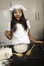 Girl cooking in kitchen.