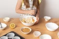 Girl is cooking muffins in the kitchen process concept ingredients simple