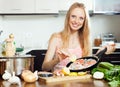 Girl cooking salmon with lemon Royalty Free Stock Photo