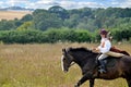 Girl riding horse in medieval dress