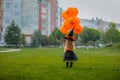 Girl in costume like a witch posing on the glade with balloons. Royalty Free Stock Photo