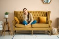 Girl on couch relaxing in living room, thinking and recalling pleasant moments