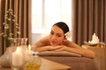 A girl could get used to this. A beautiful young woman relaxing on a massage table before her massage.