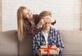 Girl Covering Brother`s Eyes Giving Him Birthday Gift Indoor
