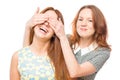 Girl covering eyes with hands to her friend Royalty Free Stock Photo