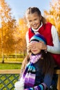 Girl covers friend face with palms and smile Royalty Free Stock Photo