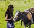 Young woman stroking a cow Royalty Free Stock Photo