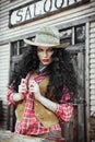 Girl in cowboy clothes and hat