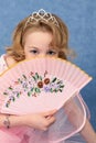 Girl coyly covered face with fan