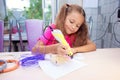 The girl creates toys using a 3D pen