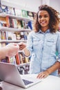 Girl with credit card at the bookshop Royalty Free Stock Photo