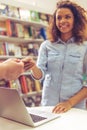 Girl with credit card at the bookshop Royalty Free Stock Photo