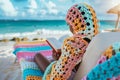 girl in a crochet coverup reading a book on a beach lounger