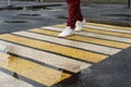 A girl crosses the road at a pedestrian crossing Royalty Free Stock Photo