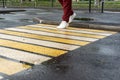 A girl crosses the road at a pedestrian crossing Royalty Free Stock Photo