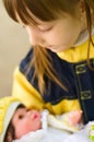 Girl cuddles and plays with her doll Royalty Free Stock Photo