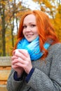 Girl with cup warm hands in yellow city park, autumn season Royalty Free Stock Photo