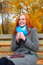 Girl with cup warm hands in yellow city park, autumn season Royalty Free Stock Photo