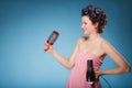 Girl with curlers in hair holds hairdreyer Royalty Free Stock Photo