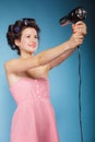 Girl with curlers in hair holds hairdreyer Royalty Free Stock Photo