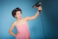 Girl with curlers in hair holds hairdreyer Royalty Free Stock Photo