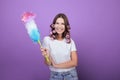 Girl in curlers and a pipidaster poses on the background