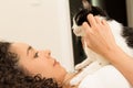 Girl with curly hair holding her lovely domestic black and white cat in bed. Concept of love to animals, pets,