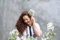 Girl among blooming apple tree