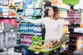 Girl customer looking at notes in shopping list