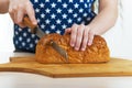 Girl cut bread with knife Royalty Free Stock Photo