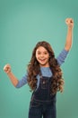 Girl cute child long curly hair happy smiling. Child psychology and development. Happy winner. Celebrate victory or Royalty Free Stock Photo