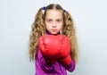 Girl cute child with red gloves posing on white background. Cute kid with sport boxing gloves. Boxing sport for female Royalty Free Stock Photo