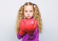 Girl cute child with red gloves posing on white background. Cute kid with sport boxing gloves. Boxing sport for female Royalty Free Stock Photo