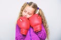 Girl cute child with red gloves posing on white background. Sport upbringing. Upbringing for leader. Strong child boxing