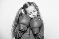Girl cute child with red gloves posing on white background. Sport upbringing. Upbringing for leader. Strong child boxing