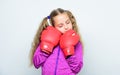 Girl cute child with red gloves posing on white background. Upbringing for leader. Strong child boxing. Sport and health