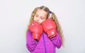 Girl cute child with red gloves posing on white background. Upbringing for leader. Strong child boxing. Sport and health