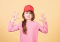 Girl cute child wear cap or snapback hat beige background. Little girl wearing bright baseball cap. Modern fashion. Kids