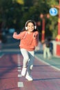 Girl cute with headphones. Little child enjoy activity. Kid walking running in park listening music. Music fills me with Royalty Free Stock Photo