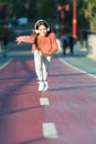 Girl cute with headphones. Little child enjoy activity. Kid walking running in park listening music. Music fills me with Royalty Free Stock Photo