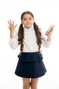 Girl cute long curly hair holds smartphone white background. Child desperate helpless face expression holds smartphone