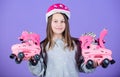 Girl cute teen wear helmet and roller skates on violet background. Roller skating teen hobby. Joyful teen going to ride Royalty Free Stock Photo