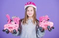 Girl cute teen wear helmet and roller skates on violet background. Roller skating teen hobby. Joyful teen going to ride Royalty Free Stock Photo