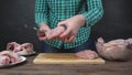 Girl cuts chicken fillet with a chef`s knife.